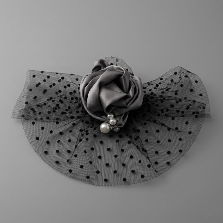 A stylish Gray Satin Rose Fascinator featuring pearl accents and polka-dot veiling by Histeria concept store.